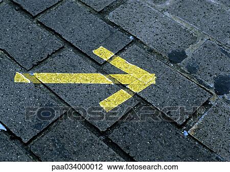 Arrow on paving stones, close-up View Large Illustration Drawing - Arrow on paving stones, close-up. Fotosearch