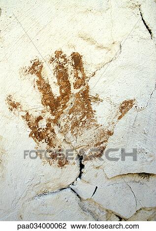Drawing - Hand print on rough surface, close-up. Fotosearch