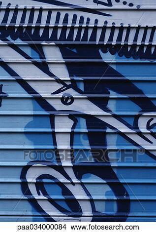 Stock Illustration - Painting of scissors on roller shutter, close-up. Fotosearch