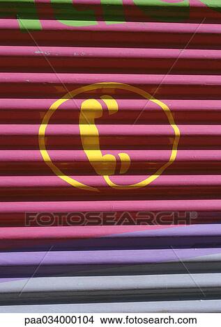 Stock Illustration - Phone sign painted on roller shutter. Fotosearch