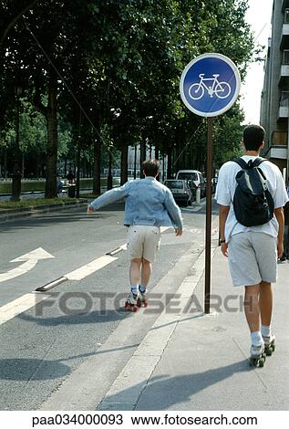 Drawing - Two people roller-skating, one on bike lane. Fotosearch