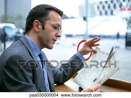Picture - Businessman reading newspaper. Fotosearch