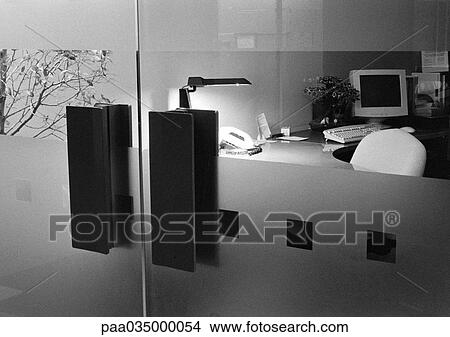 Desk behind glass doors, b&w View Large Photo Image Picture - Desk behind glass doors, b&w. Fotosearch