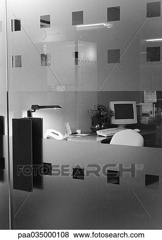 Stock Photo - Desk behind glass doors, b&w. Fotosearch