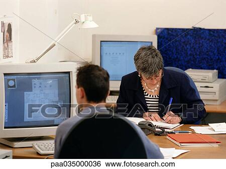 Man and woman sitting in office View Large Photo Image Stock Photograph - Man and woman sitting in office. Fotosearch