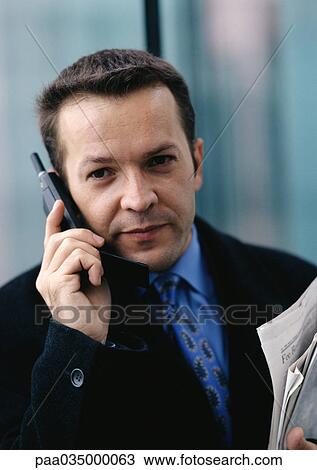 Man holding cell phone, portrait View Large Photo Image Stock Image - Man holding cell phone, portrait. Fotosearch