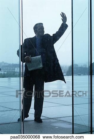 Man holding newspaper, raising hand View Large Photo Image Stock Photo - Man holding newspaper, raising hand. Fotosearch