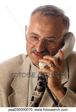 Stock Image - Man holding phone, portrait. Fotosearch