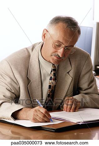Man sitting at desk, writing View Large Photo Image Stock Image - Man sitting at desk, writing. Fotosearch