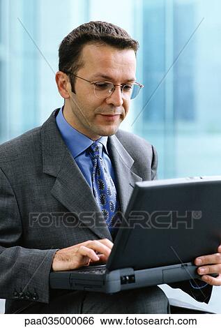 Man using laptop computer View Large Photo Image Stock Photograph - Man using laptop computer. Fotosearch
