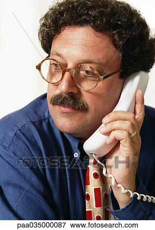 Stock Photo - Man using phone, portrait. Fotosearch