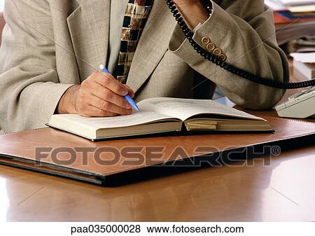 Person holding pen and using phone, mid section View Large Photo Image Stock Photo - Person holding pen and using phone, mid section. Fotosearch