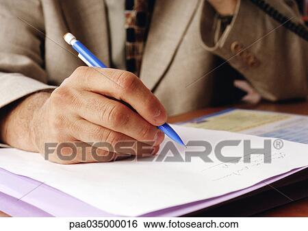 Stock Photograph - Person writing, close-up on hand. Fotosearch
