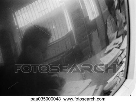 Silhouette of man sitting at desk reflected in screen, b&w View Large Photo Image Stock Photo - Silhouette of man sitting at desk reflected in screen, b&w. Fotosearch