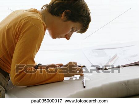 Woman Bending Over Table Holding Set Square And Pen Side View
