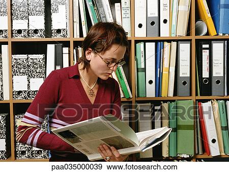 Woman holding book View Large Photo Image Stock Photo - Woman holding book. Fotosearch