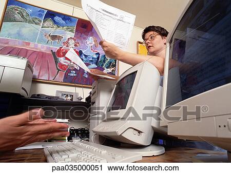 Woman leaning on computer screen, holding documents, low angle view View Large Photo Image Stock Image - Woman leaning on computer screen, holding documents, low angle view. Fotosearch