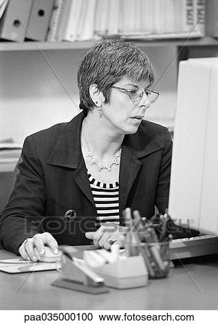 Woman sitting at computer, b&w View Large Photo Image Stock Image - Woman sitting at computer, b&w. Fotosearch