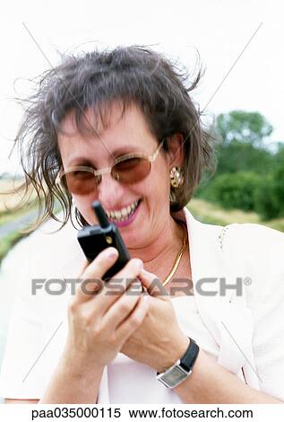 Woman using cell phone, portrait View Large Photo Image Stock Photography - Woman using cell phone, portrait. Fotosearch