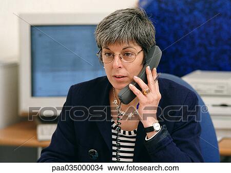 Woman using phone, portrait View Large Photo Image Picture - Woman using phone, portrait. Fotosearch