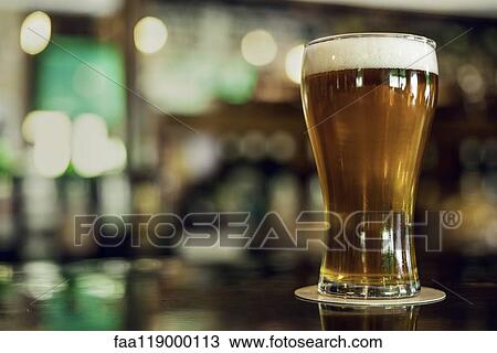 Beer glass on table View Large Photo Image Stock Image - Beer glass on table. Fotosearch
