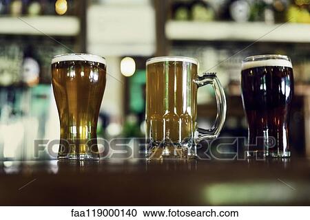 Beer glasses served on table View Large Photo Image Stock Image - Beer glasses served on table. Fotosearch