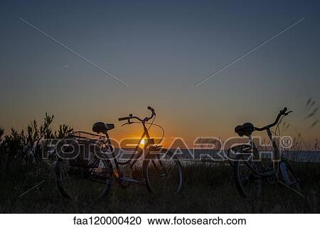 Bicycles on grassy landscape View Large Photo Image Stock Image - Bicycles on grassy landscape. Fotosearch