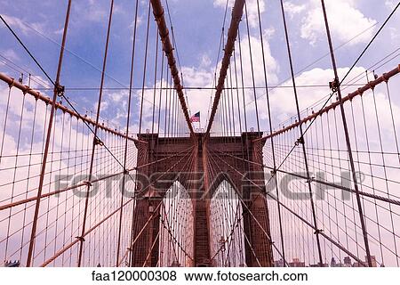 Brooklyn Bridge against cloudy sky View Large Photo Image Stock Photo - Brooklyn Bridge against cloudy sky. Fotosearch