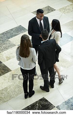 Business people discussing in hotel lobby View Large Photo Image Picture - Business people discussing in hotel lobby. Fotosearch