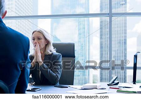 Stock Image - Business people discussing in office. Fotosearch
