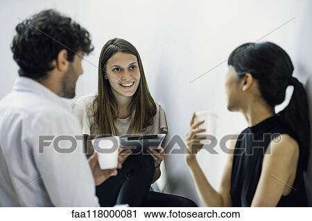 Business people discussing in office View Large Photo Image Stock Image - Business people discussing in office. Fotosearch