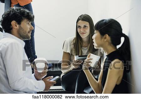Business people discussing in office View Large Photo Image Stock Image - Business people discussing in office. Fotosearch