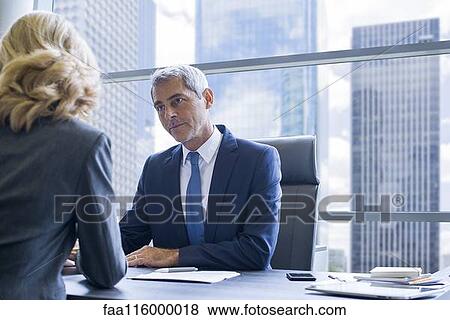 Business people discussing in office View Large Photo Image Stock Photo - Business people discussing in office. Fotosearch