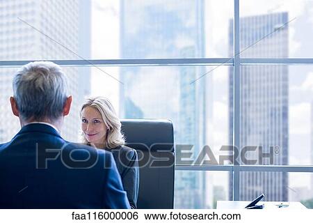 Stock Photograph - Business people discussing in office. Fotosearch