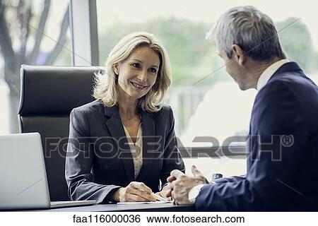Business people discussing paperwork View Large Photo Image Stock Photograph - Business people discussing paperwork. Fotosearch