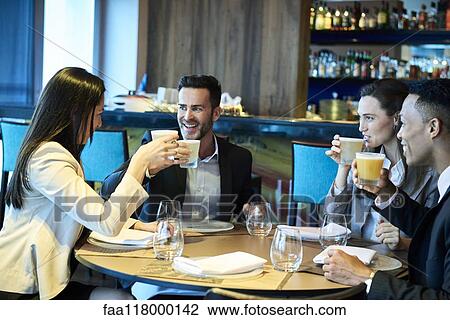 Stock Image - Business people drinking beer in bar. Fotosearch