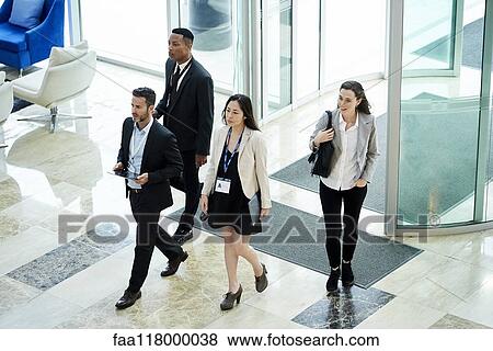 Stock Photo - Business people entering hotel lobby. Fotosearch