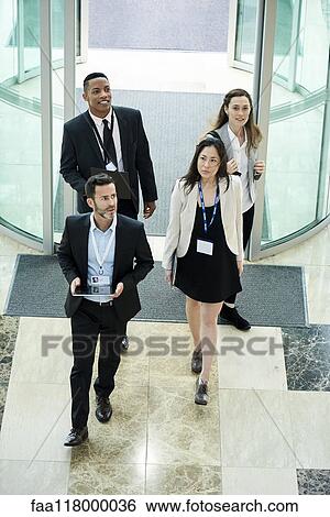 Business people entering hotel lobby View Large Photo Image Stock Photograph - Business people entering hotel lobby. Fotosearch