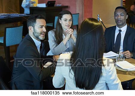 Stock Photography - Business people sitting in bar. Fotosearch