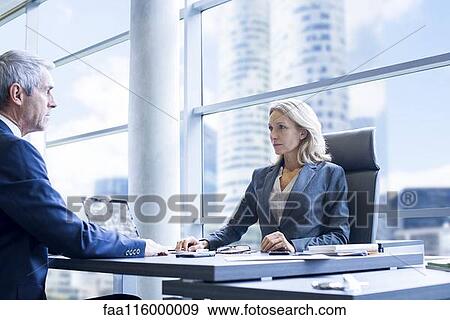 Business people sitting in office View Large Photo Image Stock Photo - Business people sitting in office. Fotosearch