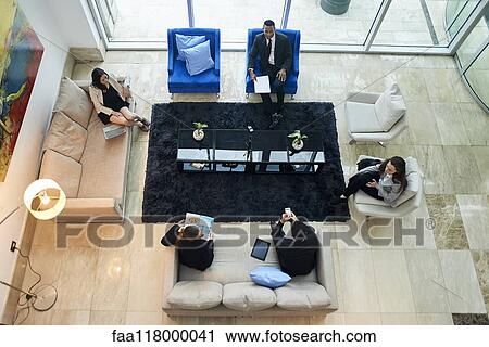 Business people talking in hotel lobby View Large Photo Image Stock Image - Business people talking in hotel lobby. Fotosearch
