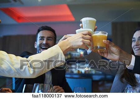 Business people toasting drink at bar View Large Photo Image Stock Photo - Business people toasting drink at bar. Fotosearch