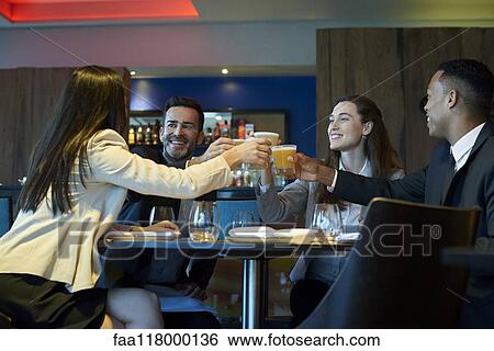 Business people toasting drink at bar View Large Photo Image Stock Photograph - Business people toasting drink at bar. Fotosearch