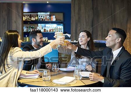 Business people toasting drink in bar View Large Photo Image Stock Image - Business people toasting drink in bar. Fotosearch