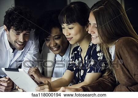 Business people using digital tablet in office View Large Photo Image Picture - Business people using digital tablet in office. Fotosearch