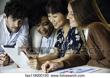 Business people using digital tablet in office View Large Photo Image Stock Image - Business people using digital tablet in office. Fotosearch