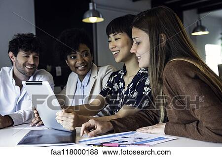 Business people using digital tablet in office View Large Photo Image Stock Photo - Business people using digital tablet in office. Fotosearch