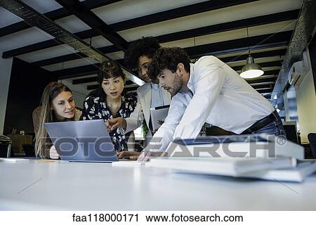 Business people using laptop in office View Large Photo Image Stock Image - Business people using laptop in office. Fotosearch
