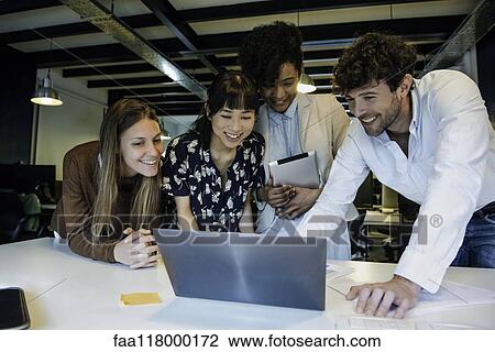 Business people using laptop in office View Large Photo Image Stock Image - Business people using laptop in office. Fotosearch