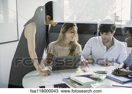 Stock Image - Business people working in office. Fotosearch